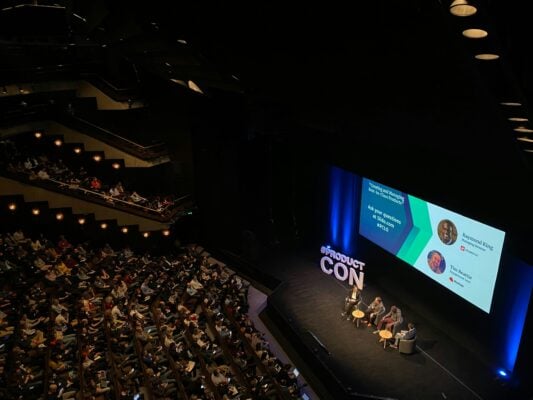 Camcorder recording a speaker at a live panel event